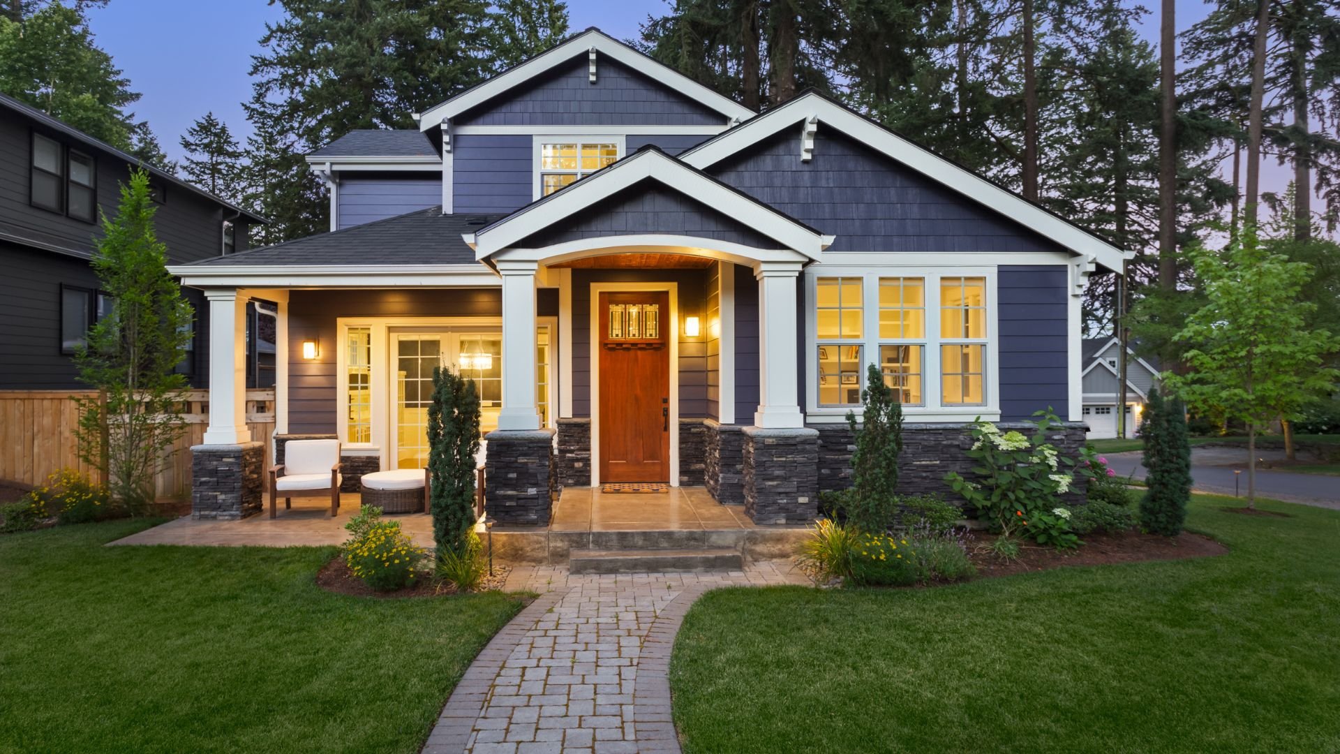 Modern craftsman-style house with blue siding, white trim, and welcoming front porch